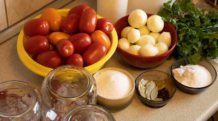 close-up of the ingredients needed to can tomatoes at home, salt, sugar, bay leaf, peppercorns and parsley and of course tomatoes and glass jars