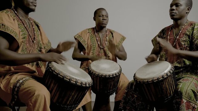 Traditional african drummers play rhythm on traditional drums