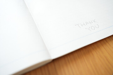 Thank You Text on White Notebook Page with Pencil