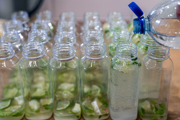 Plastic bottles filled with homemade lime mint soda.