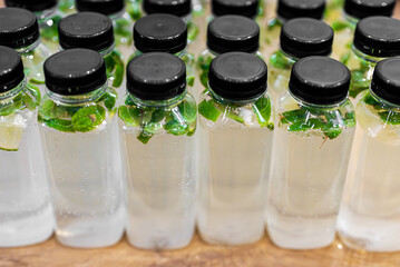 Plastic bottles filled with sparkling lime mint water.