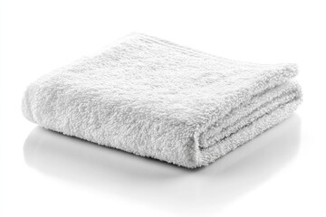 Folded white spa towel ready for relaxation and personal care on a clean, reflective surface