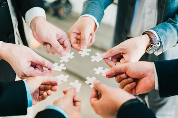 business concept shown through a jigsaw puzzle, where each piece connects to build strategy teamwork and success in the corporate.