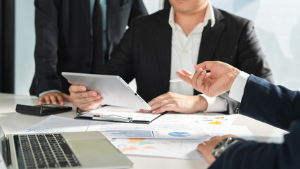 businessman holds a pen while clarifying and discussing business information at the office table, providing clear insights during  professional meeting.