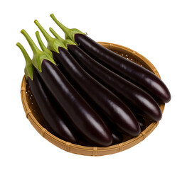 Dark purple eggplants in a light brown woven basket on a black background