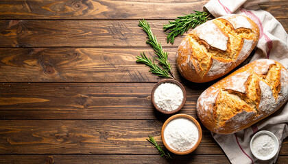 Fresh bread on wooden board with copy space, top view, healthy food concept for World Food Day, bakery, wholesome and rustic style