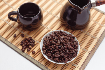 Roasted coffee beans, cezve and espresso coffee cupб Items for preparing Turkish coffee,