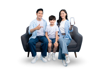 Obraz premium A happy family of three posing on a gray sofa, with mother holding a smartphone showing blank screen on PNG 