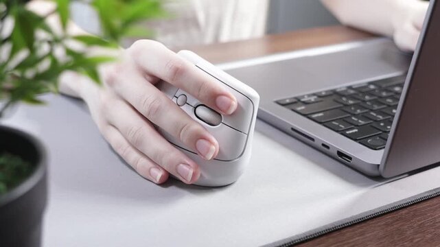 Person's hand comfortably using a vertical mouse, showcasing ergonomic design to prevent wrist strain and tunnel syndrome, ensuring healthy productivity