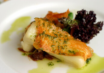 Portugal. Fried sun dried salted codfish with the skin and a fresh crispy salad.