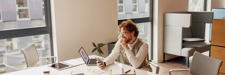 A focused individual engages in their work while comfortably sitting in a stylish, modern office fostering productivity