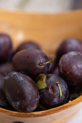 Plums in a wooden bowl