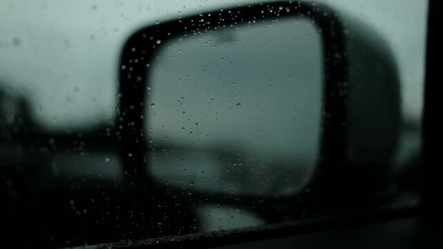 Raindrops on a car window, macro, blurred background, cloudy and dark weather