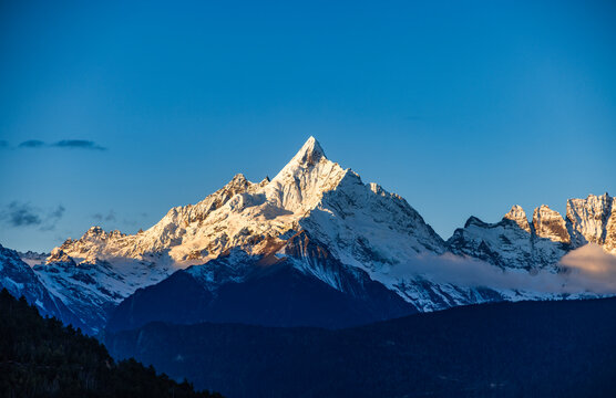 Aerial view of the Golden Mountain bathed in sunlight on Meili Snow Mountain in Yunnan Province