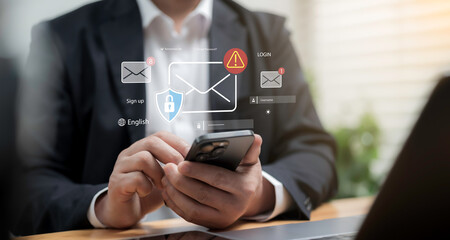 Businessman using smartphone with email security icons showing login, password protection, spam alert and phishing warning, representing secure communication, privacy and safety in digital business