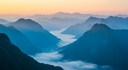 Fototapeta premium Majestic Mountain Landscape with Blue Hues and Misty Valleys at Sunrise