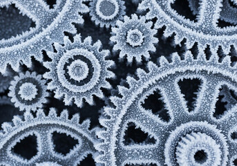 Frozen gears machine winter frost mechanism engineering technology industrial cogwheel teamwork concept
