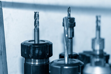 Close-up scene the used flat nose or square shape end mill tools in the blue tone scene.