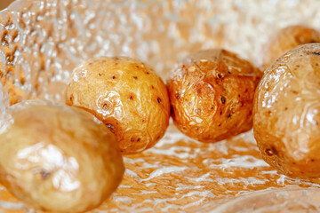 Young baked potatoes in close-up. The golden hue gives it a special beauty.