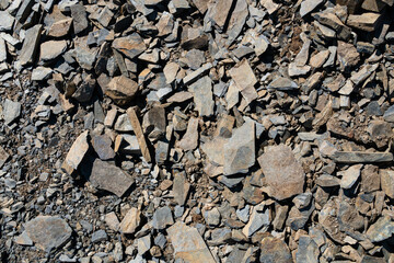 A close-up of the texture of rough, broken rock. The image captures the natural process of decay and weathering, ideal for use in environmental, geological or natural history work.