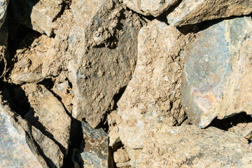 A close-up of the texture of rough, broken rock. The image captures the natural process of decay and weathering, ideal for use in environmental, geological or natural history work.