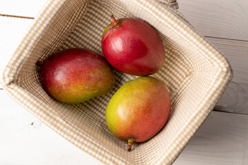 Sweet juicy mangoes on a wooden table, top view, macro.