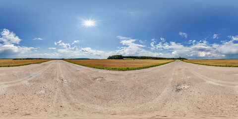 hdri 360 panorama view on crossroads of gravel country roads among fields with clouds in sky in...