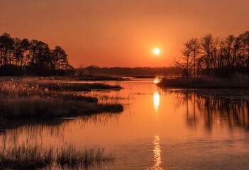 Obraz premium A tranquil sunset over a calm river