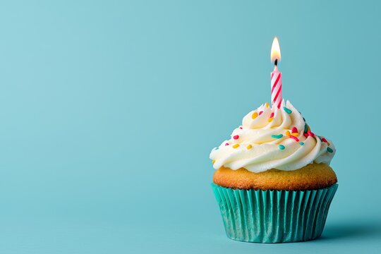 Cupcake with one candle on blue background symbolizing first birthday celebration, minimal web banner design with copy space for online business anniversary