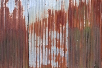 Rusty metal roof. Vintage style metal sheet roof texture. Pattern of old metal sheet. Rusting metal or siding. Corrosion of galvanized. Background and texture in retro concept © Fauzi Stock