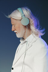 Elderly man with long white hair wearing pastel blue headphones, side profile against a gradient background, creating a calm and serene atmosphere for music enthusiasts