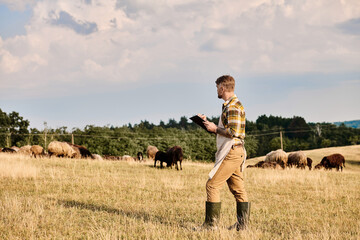 Modern farmer tending to livestock in a tranquil rural landscape under a blue sky