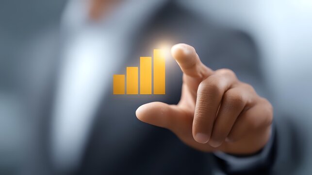 Business professional pointing at glowing yellow bar graph chart showing upward trend and growth, demonstrating financial success and market performance analysis.