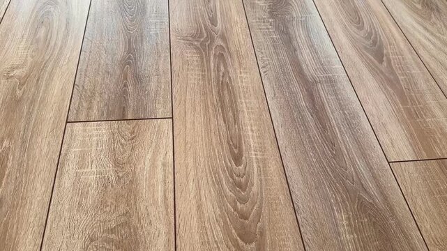 Wooden natural laminate on floor. Laying laminate flooring. Laminate laying scheme. Natural