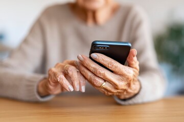 An Elderly Person Engaging with a Smartphone, Highlighting the Interactions Between Technology and Older Generations in Daily Life
