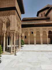 Obraz premium The iconic Patio de los Arrayanes at the Alhambra, with its marble pillars, intricate carvings, and serene water feature.