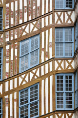 Traditional Half-Timbered Facade with Blue Windows in Historic European Architecture
