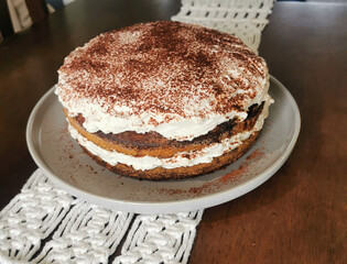 Classic Italian tiramisu cake with coffee-soaked layers, mascarpone cream, and cocoa powder. Perfect dessert for celebrations