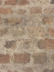 Close-up of an old, weathered brick and mortar wall, showcasing a rustic, uneven texture perfect for backgrounds and patterns