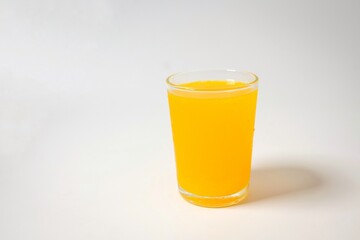 Orange juice in a glass on white background