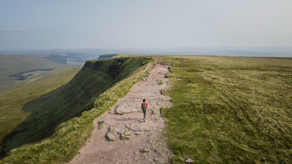 Backpacker hiking in Bannau Brycheiniog National Park, Brecon Beacons in South Wales