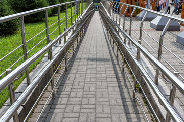 Wheelchair ramp with handrails. Accessibility and architecture