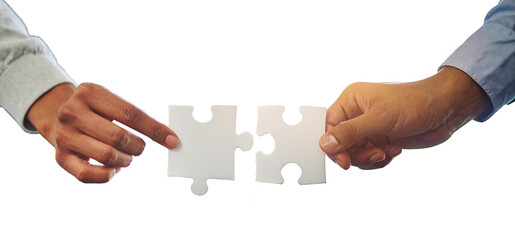 Two professional hand connecting two puzzle pieces on a desk