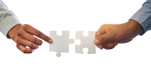 Two professional hand connecting two puzzle pieces on a desk
