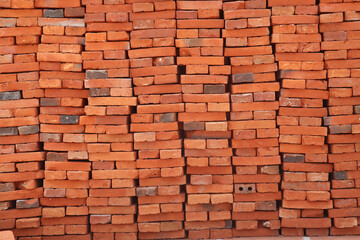 Fototapeta premium Large pile of construction bricks stacked neatly together forming strong rectangle