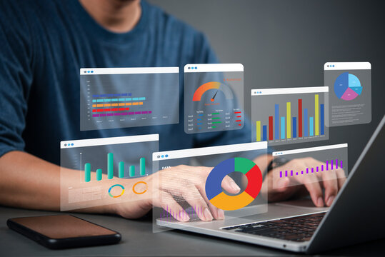 Business analyst working on laptop with holographic dashboard charts and data visualization graphs. Concept of big data, analytics, business intelligence, and financial statistics. crm marketing