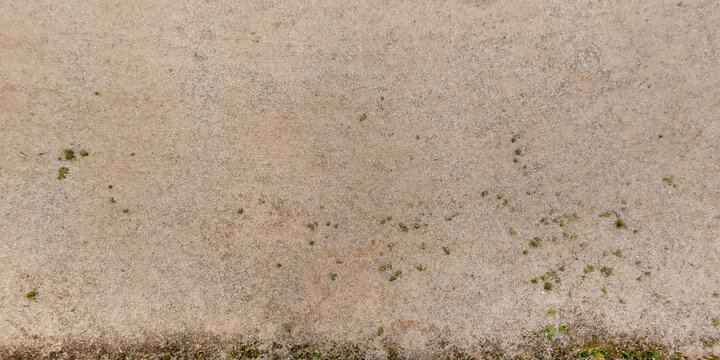 top view of gravel road surface with tractor tire tracks in countryside