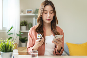 Mindful Health Habits: Engaging in Informed Wellness - A Person Deliberates Supplement Information Before Consumption for Optimal Nutritional Awareness and Personal Well-being.