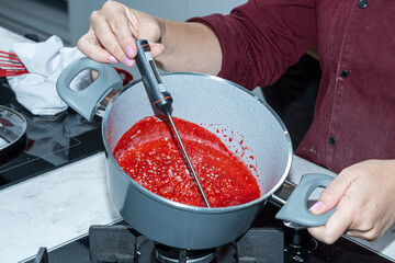 Chef measuring the temperature of the berry topping_front view.