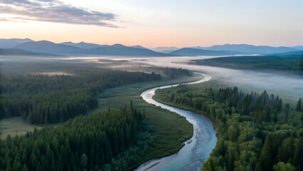 Obraz premium Aerial of winding river over forest and meadows at sunrise